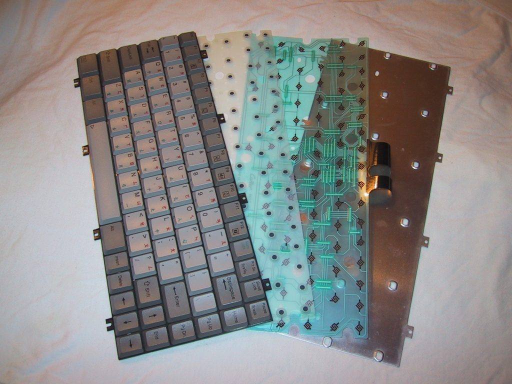 Best Keyboard For Software Development: The inside of a keyboard showing the internals of membrane switches.